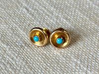 pair of gold stud earrings front view