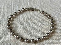 Full view of sterling silver bead bracelet laid flat