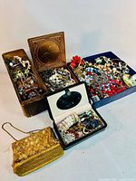 Overview of multiple boxes filled with jewellery and evening purse