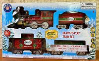 Front of boxed Lionel North Pole Central ready-to-play train set showing locomotive, tender, gondola, caboose