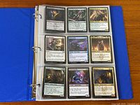 Binder open showing nine Magic card fronts on right page