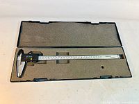 Caliper in open foam-lined plastic case