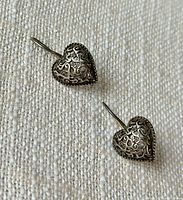 Front view of both heart earrings showing filigree detail