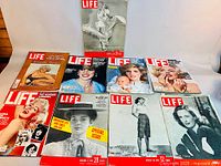 Group shot of all eight LIFE magazines laid out showing covers