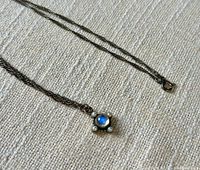 Full view of necklace laid out showing chain style and pendant position