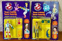 Front view of both sealed action figures on cards