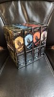 Four James Bond Ultimate Edition DVD volumes side by side showing numbered spines
