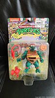 Front view of sealed Michelangelo Pizza Tossin' figure with accessories