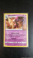 Front view of sleeved Mismagius holo card