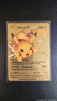 Front of Pikachu V gold metal card in sleeve
