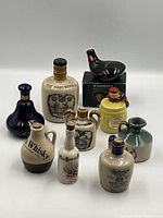 Group shot of all ten miniature ceramic decanters