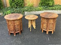 All three carved side tables front view