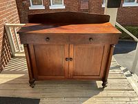 Full front view of walnut sideboard on porch
