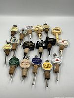 Full group of 17 branded pourers laid out in three rows