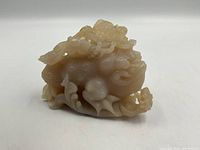 Front three-quarter view of carved stone dragon