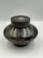 Front view of lidded cloisonné jar showing dragon design