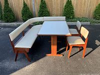 Full set angled view showing table, both benches, both chairs