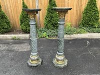 Both marble pedestals full view on pavement