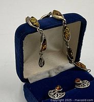 Bracelet and earrings displayed in blue velvet box