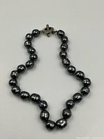 Full view of pearl necklace showing clasp and overall length