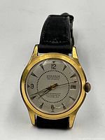 Front view of watch showing dial, hands, markers, and gold-tone case