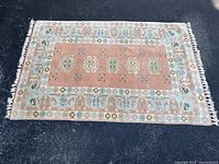 Full view of rug showing pattern and fringe