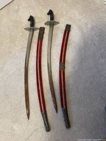 Full view of both swords with scabbards laid out