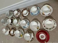 All 16 bone china teacup and saucer sets displayed