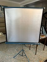 Screen fully extended on tripod stand