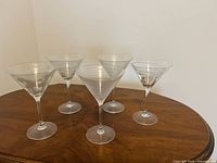 Group shot of all five etched martini glasses on tabletop