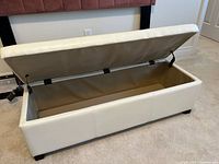 Ottoman open showing hinged lid and interior storage