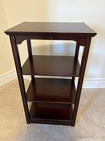 Front view showing three shelves and finish