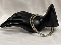 Pair of twisted silver bangles on display hand
