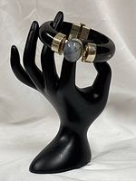 Full view of black horn bangle on display hand showing overall design