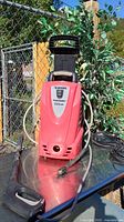 Front view of Husky pressure washer with hose and wand visible