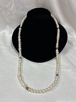 Full view of pearl necklace displayed on bust