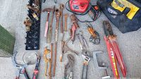 Entire lot spread out showing all tools including charger, jack, valves, bag