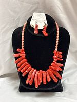 Necklace and earrings on display bust