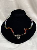 Full view of necklace on display bust showing all beads and pendant