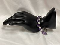 Bracelet shown on display hand, full view of bead pattern and clasp