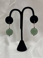 Full view of both earrings on stand showing overall design and colour