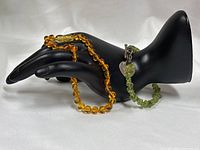 Both bracelets displayed on mannequin hand