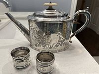 Teapot with bone finial and both napkin rings displayed