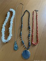 overview of all four necklaces laid out side by side