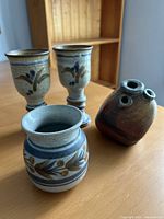 Group shot of all four signed stoneware vessels