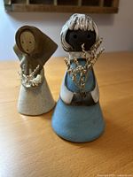 Front view showing both figurines and dried flowers