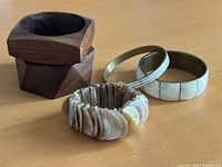 All five bangles and bracelet grouped together on tabletop