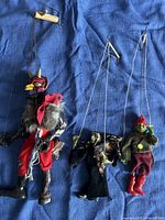 Overview of devil and two smaller puppets with control strings