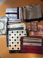 All eight scarves folded to show patterns and brands