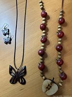 Overview of both necklaces and earrings laid out on table